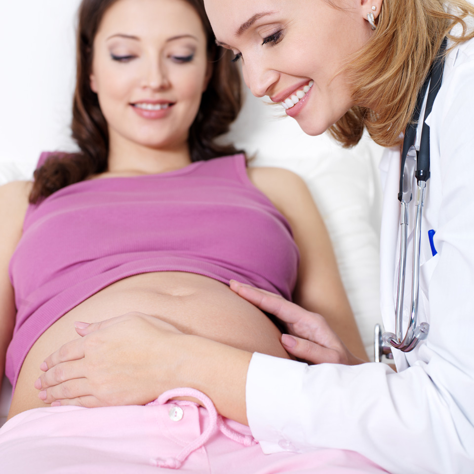 Gynäkologin untersucht Schwangere auf äußere Anzeichen von Gerinnungsstörungen.